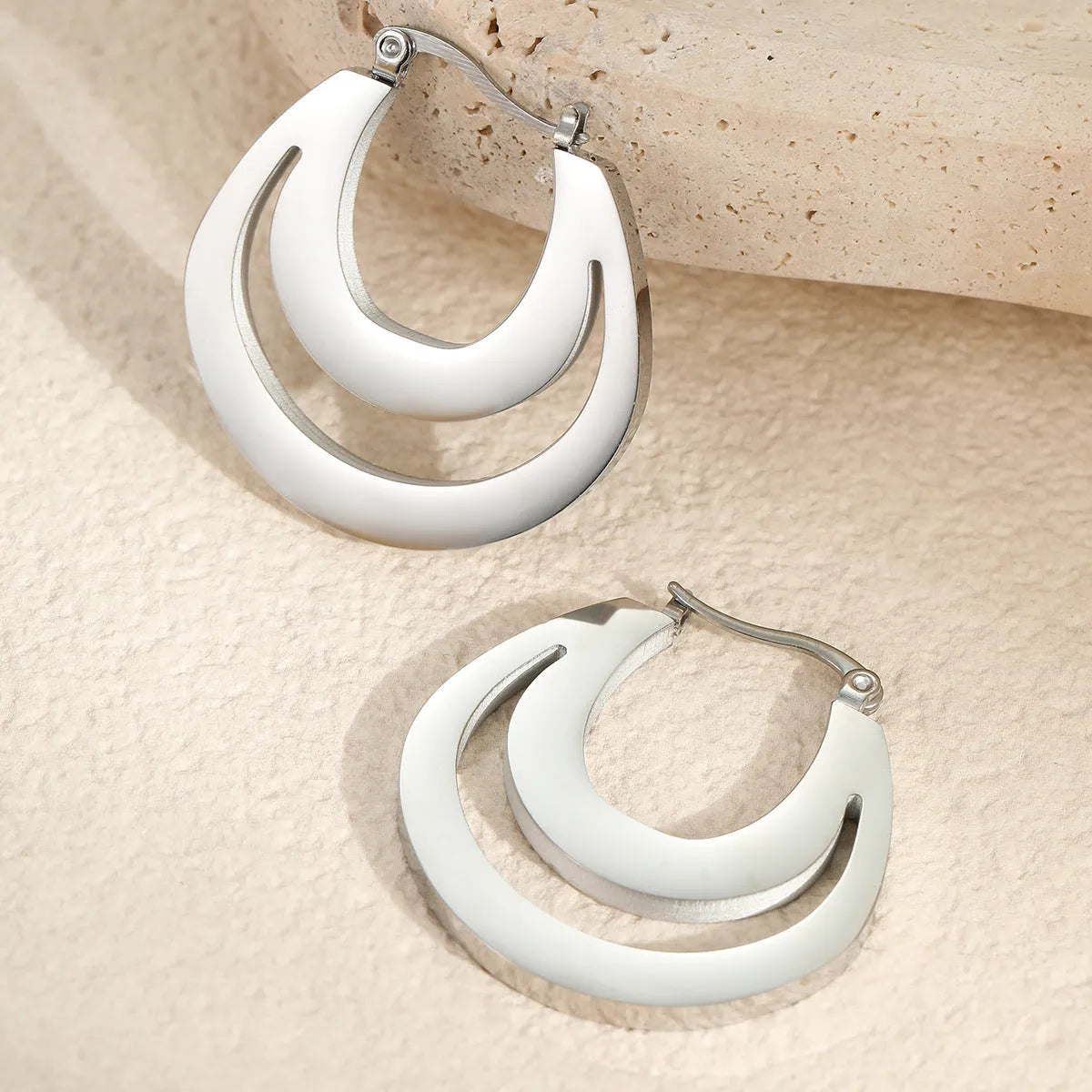 Geometric gold-plated French earrings with stainless steel construction and round ring design elements