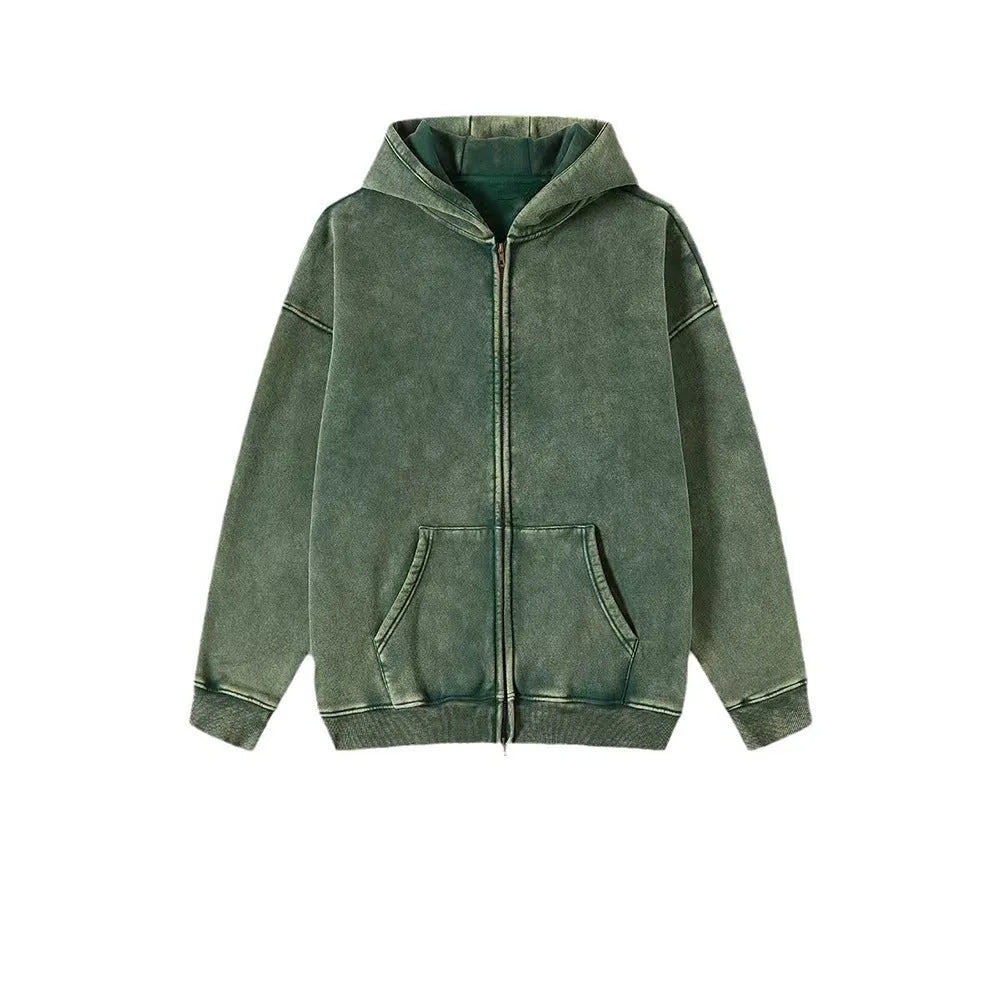 Man wearing a dark green fleece-lined hooded cardigan sweater with a double zipper.