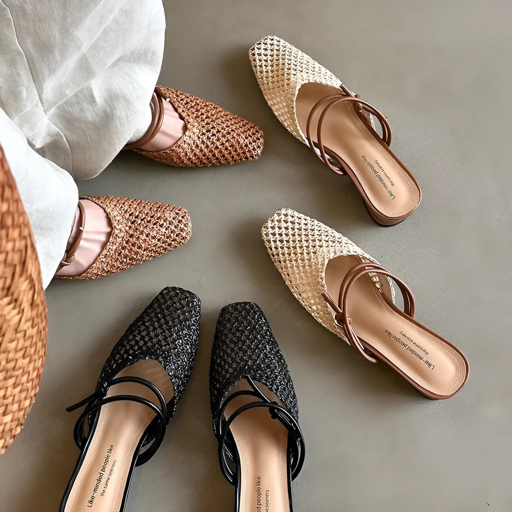 Women's black French-style square toe slippers with hollow-out design and a chunky mid-heel on a rubber sole.