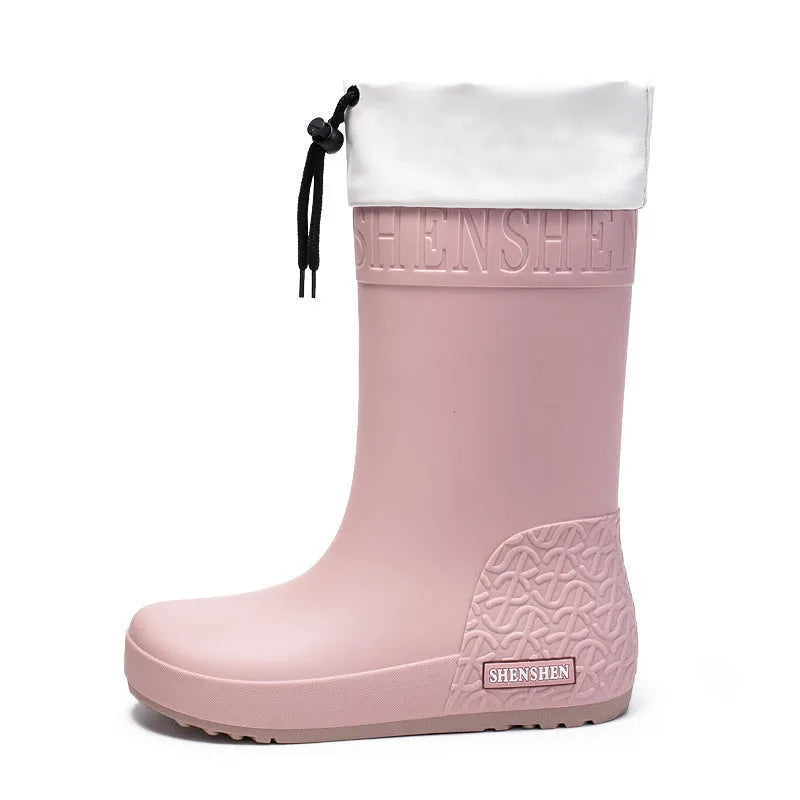 Women's solid colour PVC rain boots with non-slip soles in apricot, black, brown, and pink.