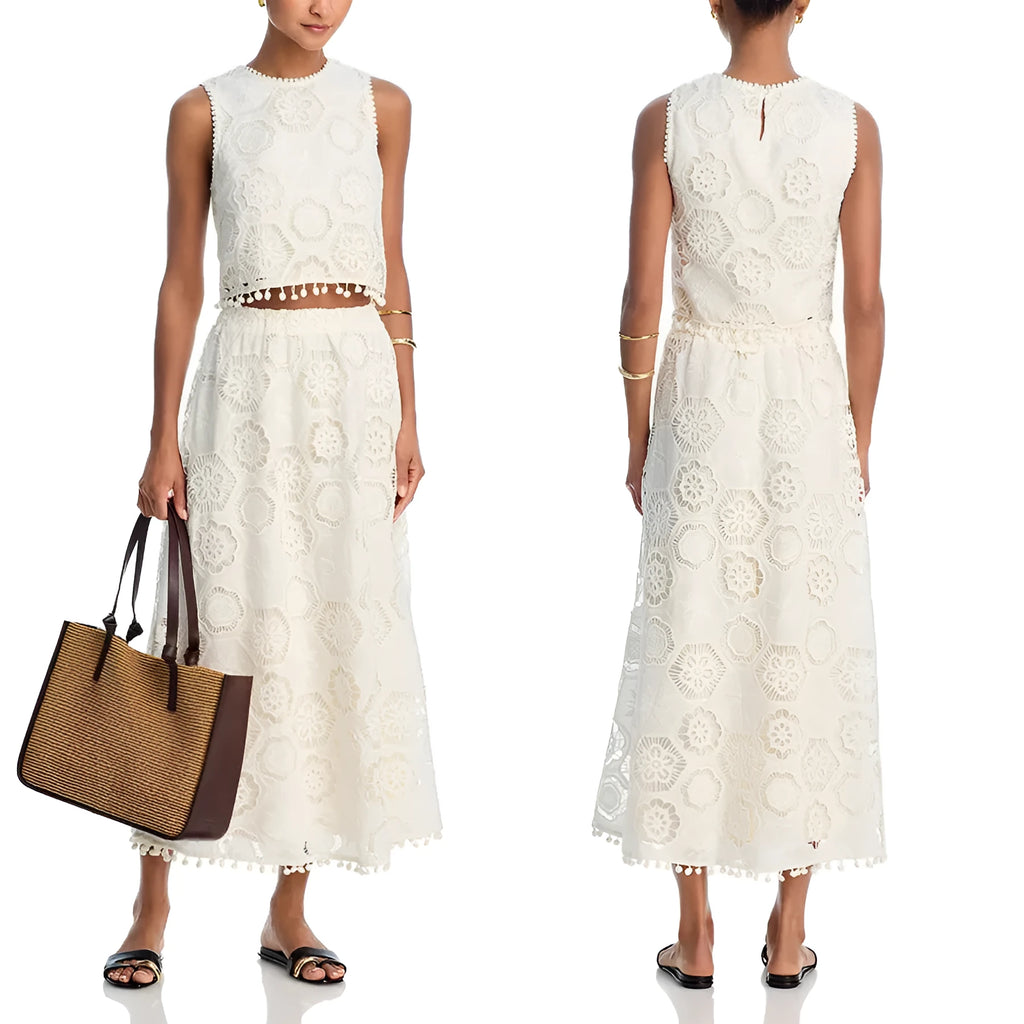 White women's sleeveless top and long skirt suit set with retro embroidery on a hanger