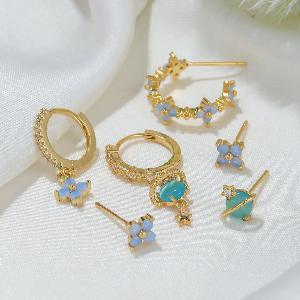 Gold and silver Japanese Korean style flower ear studs with blue flower nail and zircon mosaic design.