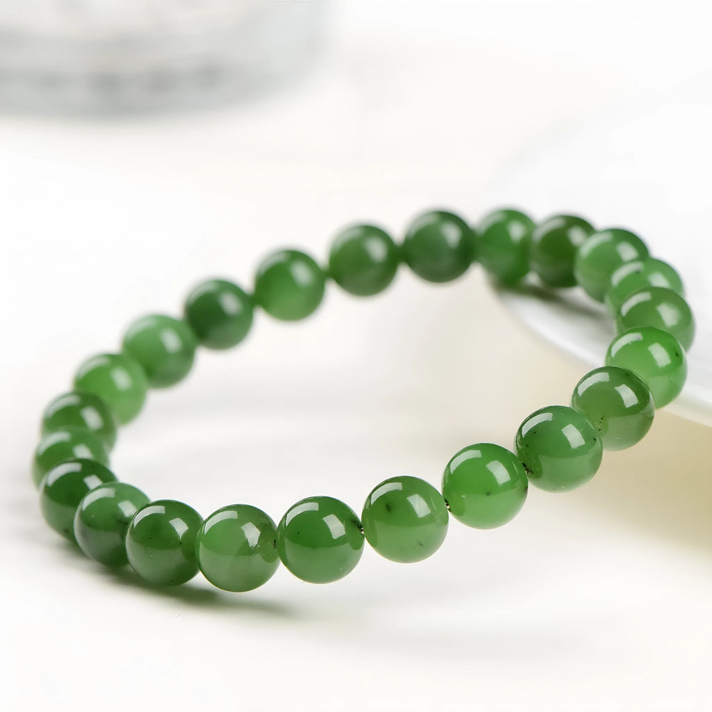 Natural Hetian jade beaded bracelet in various bead sizes on a plain background.