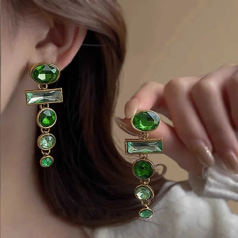 Green gradient geometric alloy earrings with dangling tassels and inlaid zircon stones.