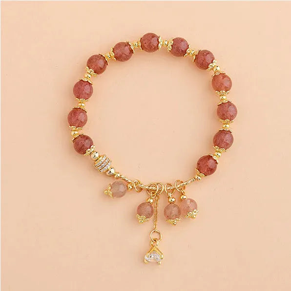 Pink women's crystal bracelet with heart-shaped charms and pearl decorative accents