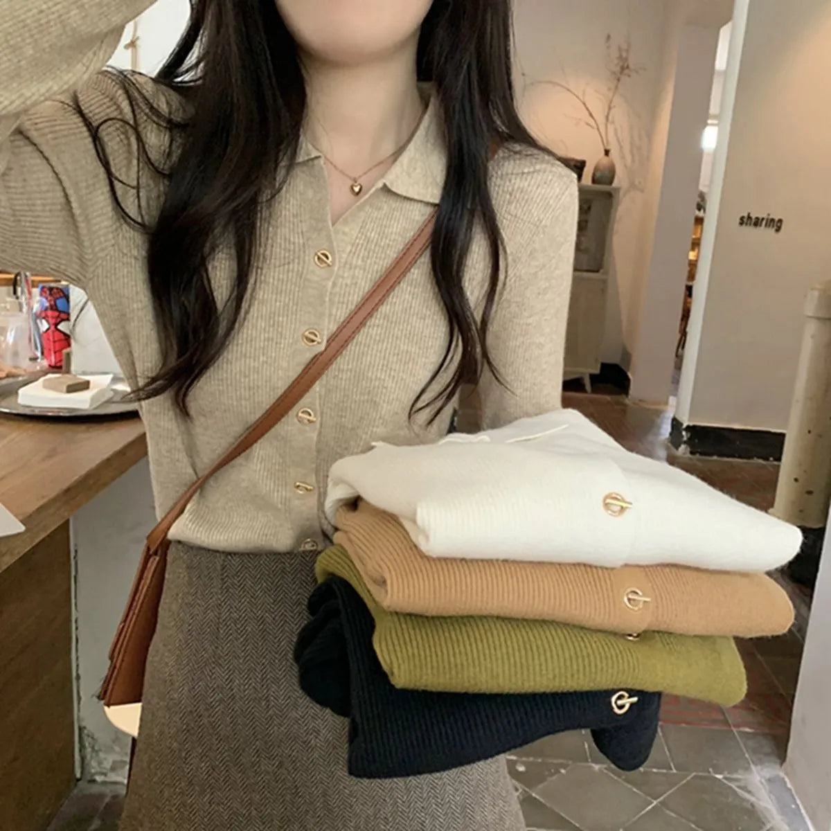 Loose fit beige viscose knitted cardigan top with long sleeves on a hanger