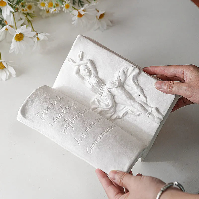 Ceramic book stand with glazed surface in a modern design, displayed on a desktop.