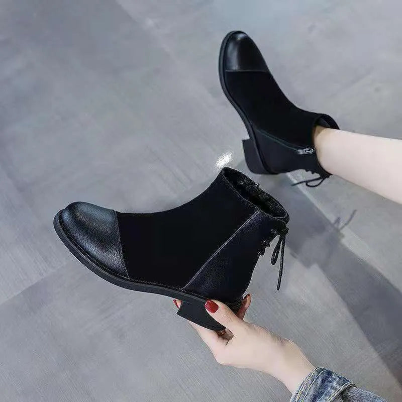 Black women's knee boots with side zip, round toe, short heel and decorative bow.