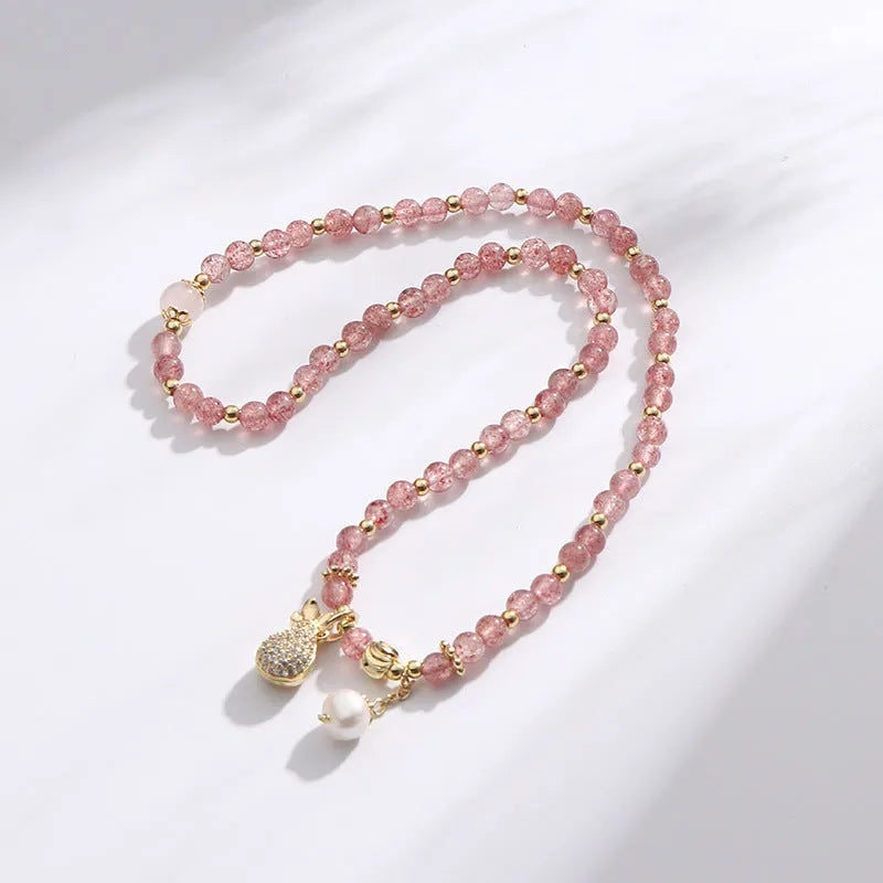 Women's geometric strawberry quartz crystal bracelet for money drawing and luck.