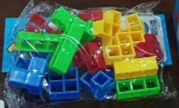 Plastic balance stacking board game with 16 coloured blocks, chassis, and base on a table