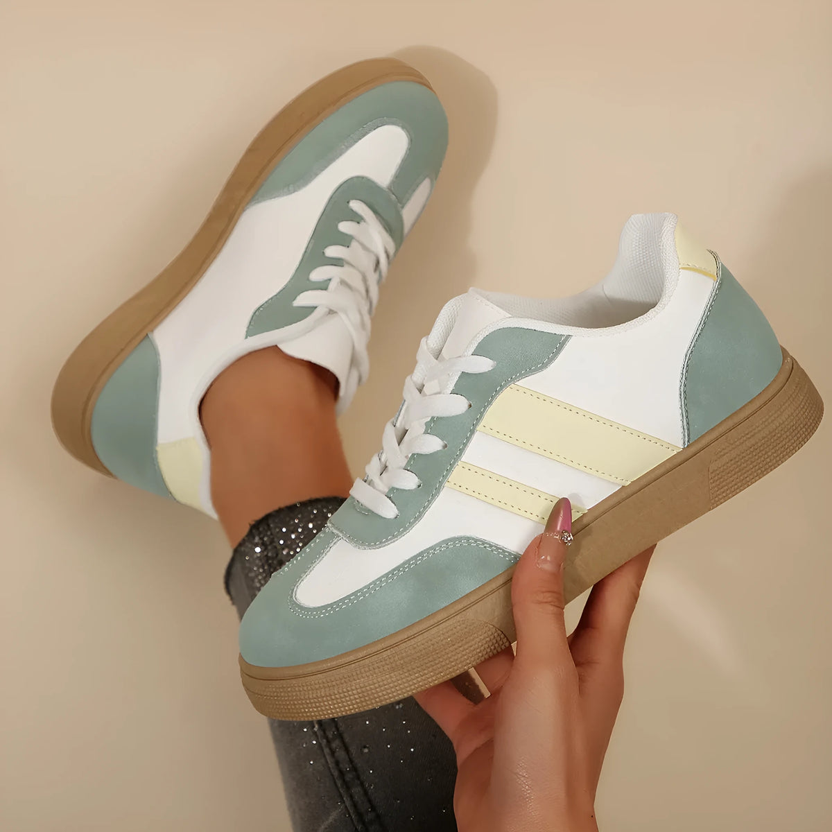 Green women's low-top casual pumps with cross-strap design and flat rubber sole.