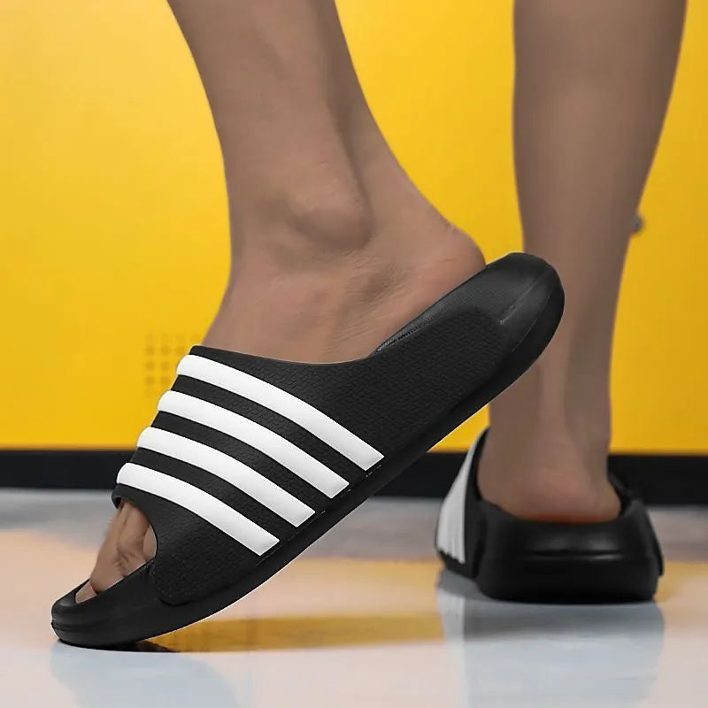 A pair of casual unisex slippers with a PVC upper and EVA sole, shown in one of four available colour options.