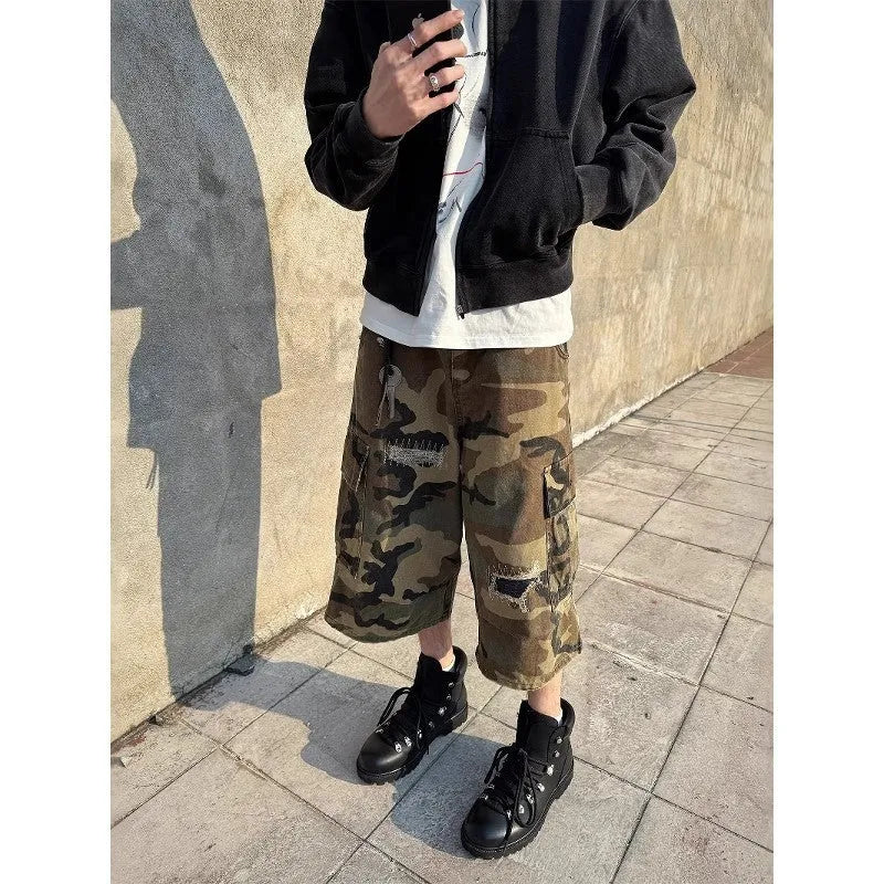 Men's camouflage cropped jeans with patchwork and ripped detailing in straight-leg loose fit