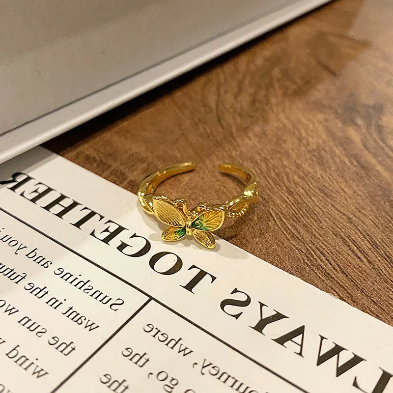Copper butterfly women's ring with drip oil finish in an open-loop design.