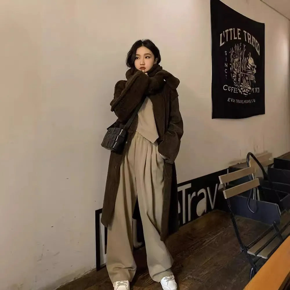 Brown women's loose fit casual sports suit set with long sleeve top and trousers on a model.