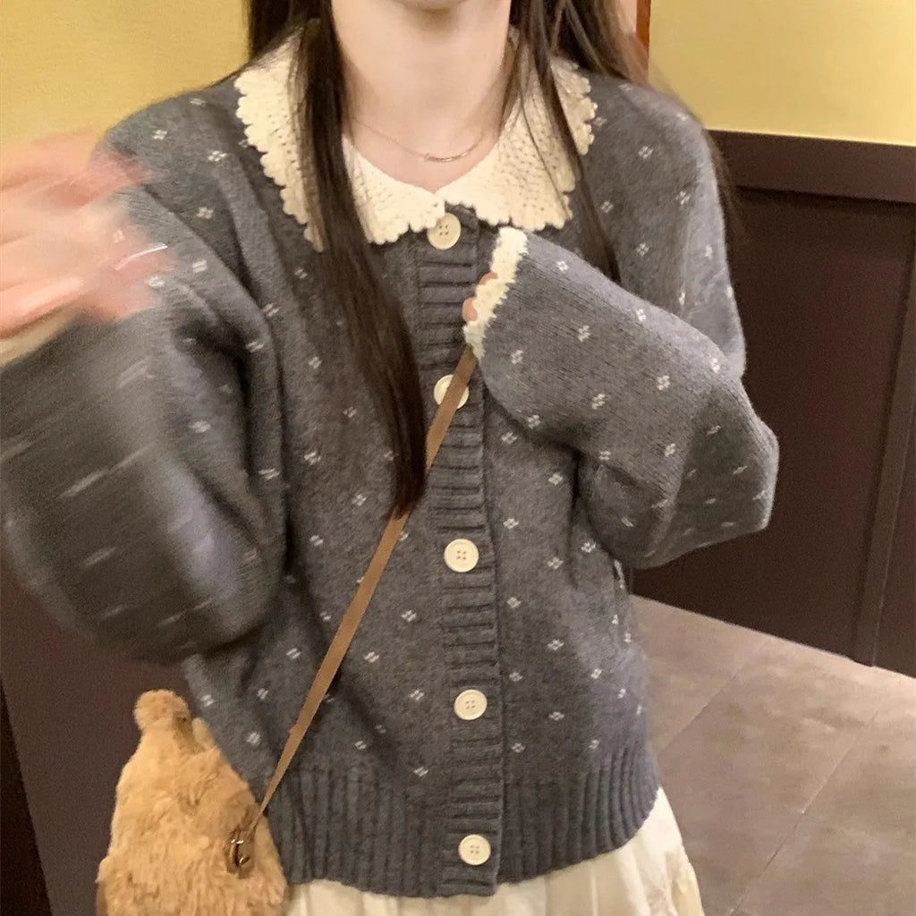 Navy blue floral patterned knitted cardigan coat with a white Peter Pan collar and button front.