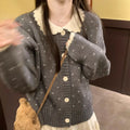 Navy blue floral patterned knitted cardigan coat with a white Peter Pan collar and button front.