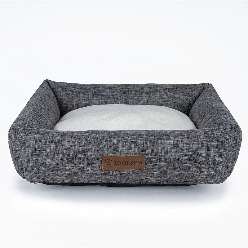 Square grey linen dog bed on a wooden floor for autumn and winter.