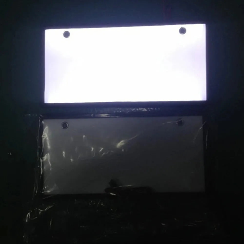 Two white plastic LED license plate lights for truck rear installation.