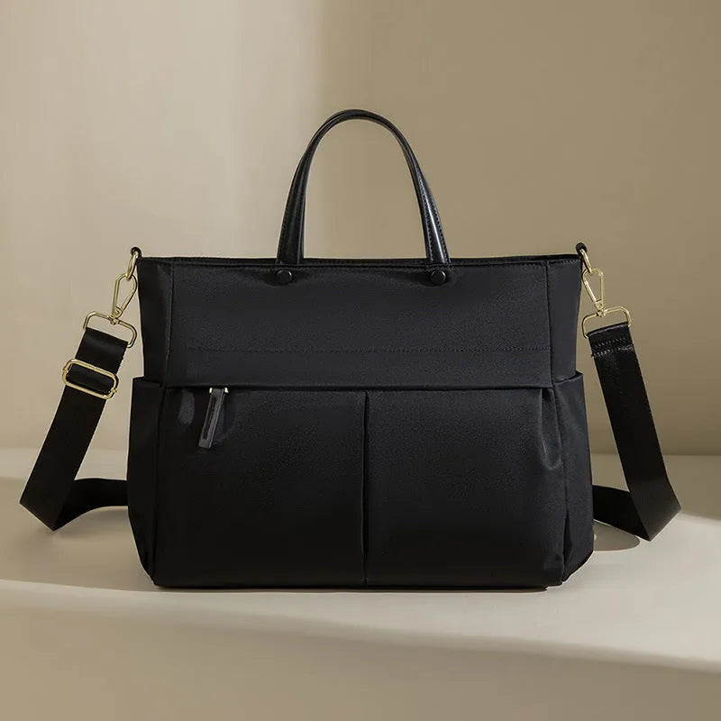 Women's Oxford cloth laptop briefcase in elegant black colour with open pockets and contrast stitching