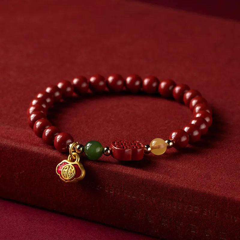 Happy Eyebrow Bracelet with fu character bead on raw emperor sandstone cinnabar beads.
