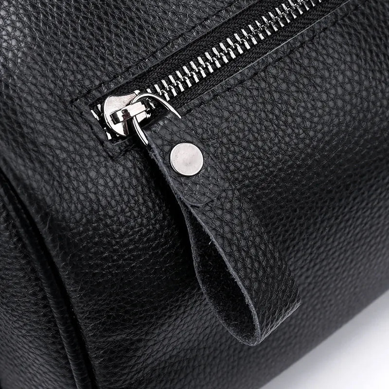 Black genuine leather one-shoulder crossbody bag showing front view and adjustable strap.