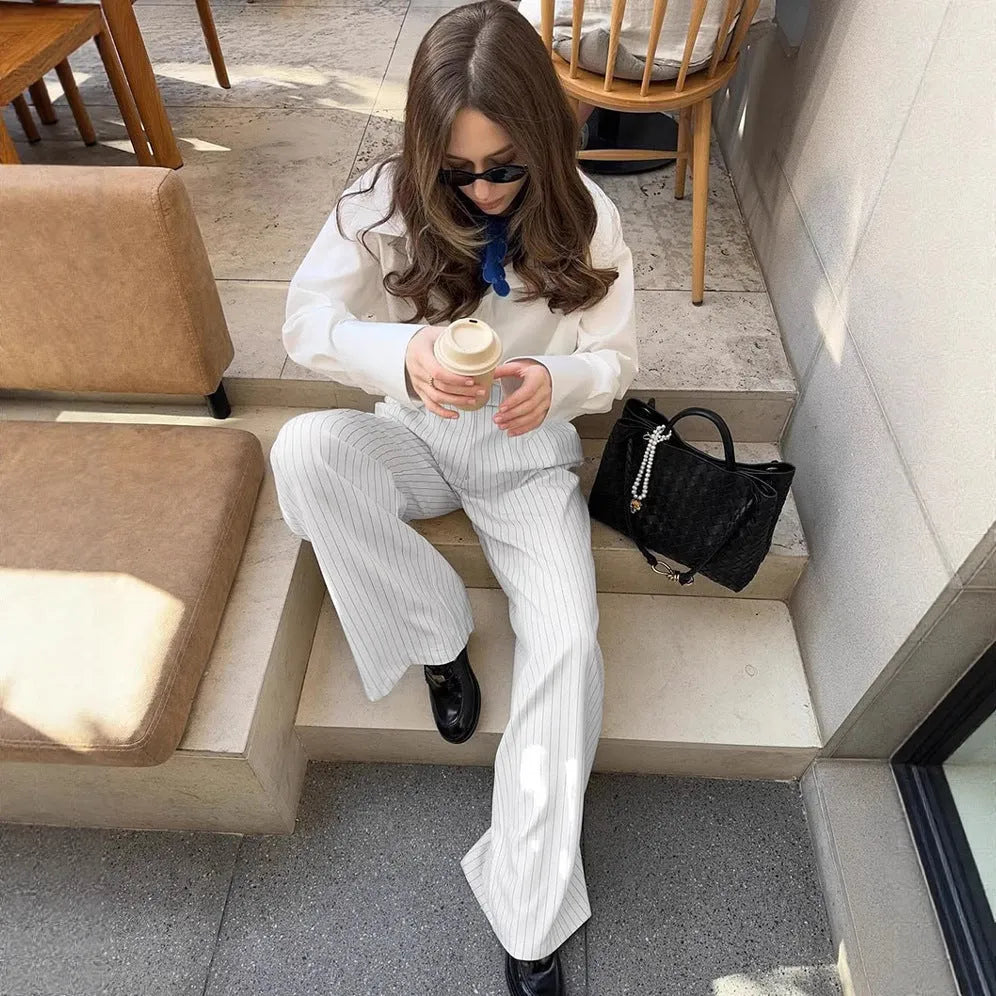 White striped wide-leg casual trousers with a zip closure on a hanger