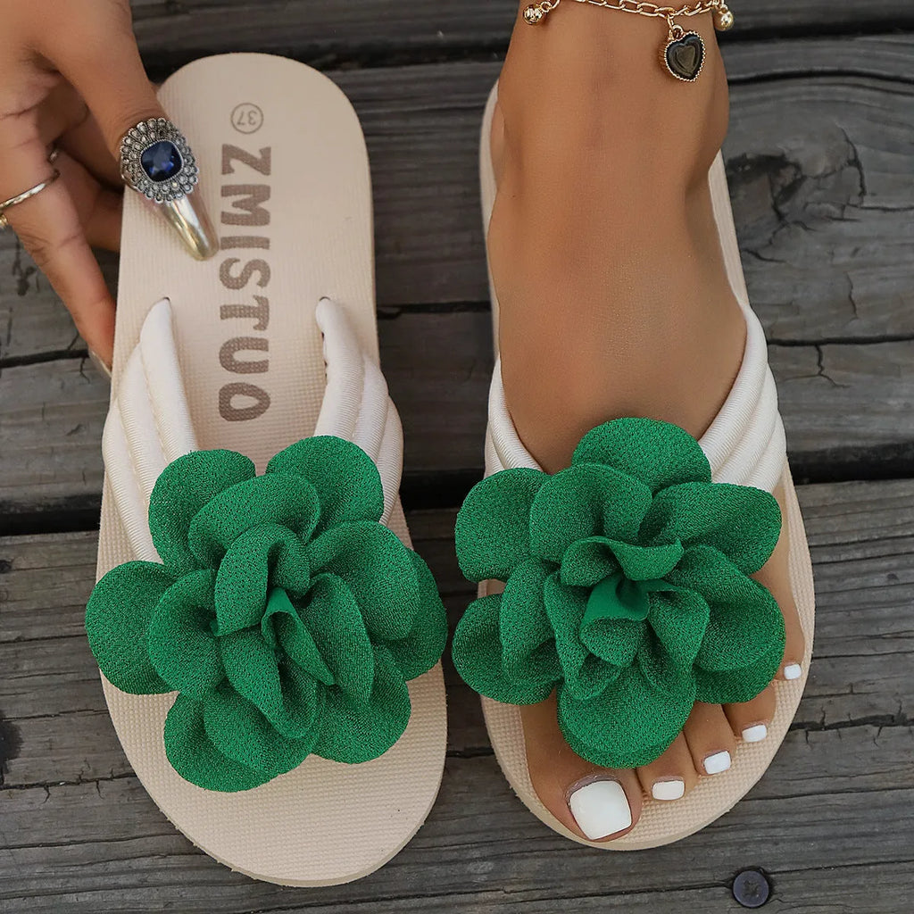 A pair of plus size floral design flip flop slippers in creamy-white with a PU upper and sole.