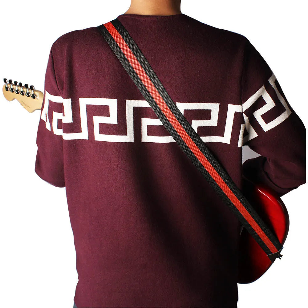 Woven crossbody musical instrument strap in multiple colours with clip-on hooks for guitar, bass, and ukulele.