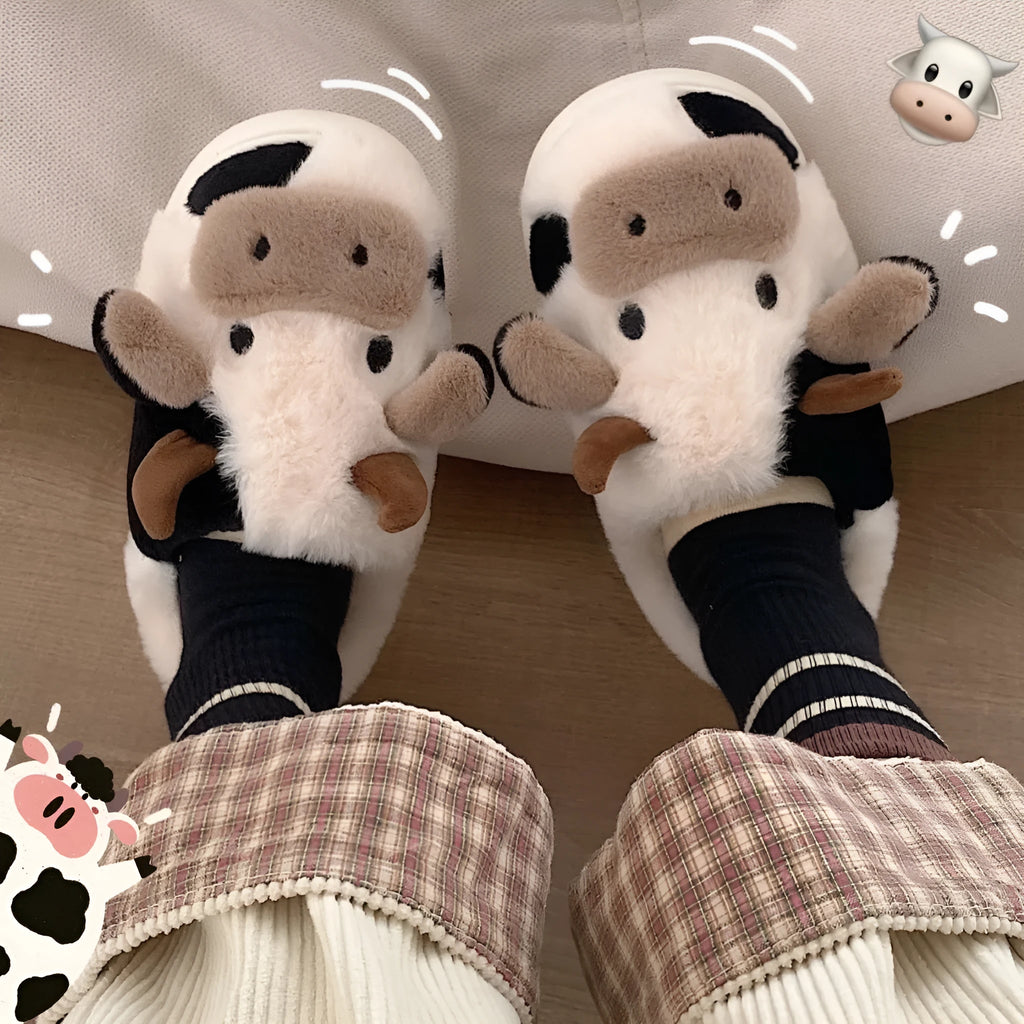 White and coffee coloured cow-themed plush slippers for women with a textured non-slip sole.
