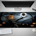 Oversized Halloween pattern mouse pad on a desk showing non-slip rubber base and cloth top.