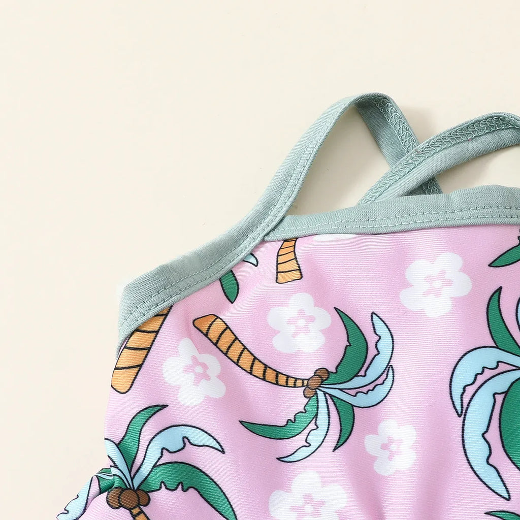 Girls' white two-piece swimsuit set with a shirt top and shorts on a hanger.