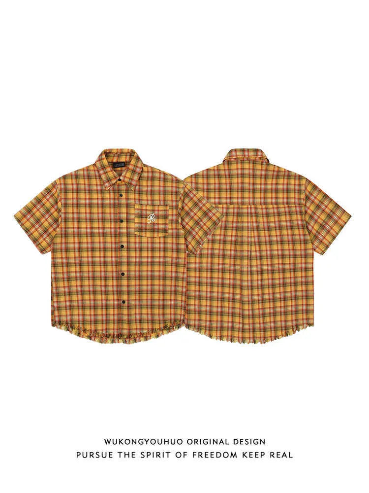 Yellow and white check short sleeve shirt with an embroidered chest pocket on a loose fit.