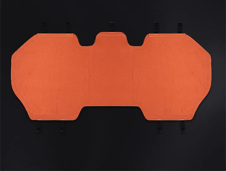Genuine leather and fur car seat cover with patterned ventilation holes on a car seat.