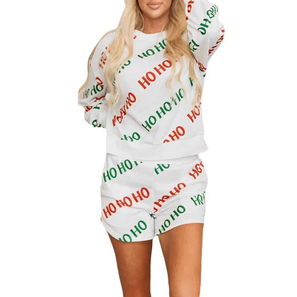 White women's two-piece suit with letters print on long-sleeved top and matching trousers.