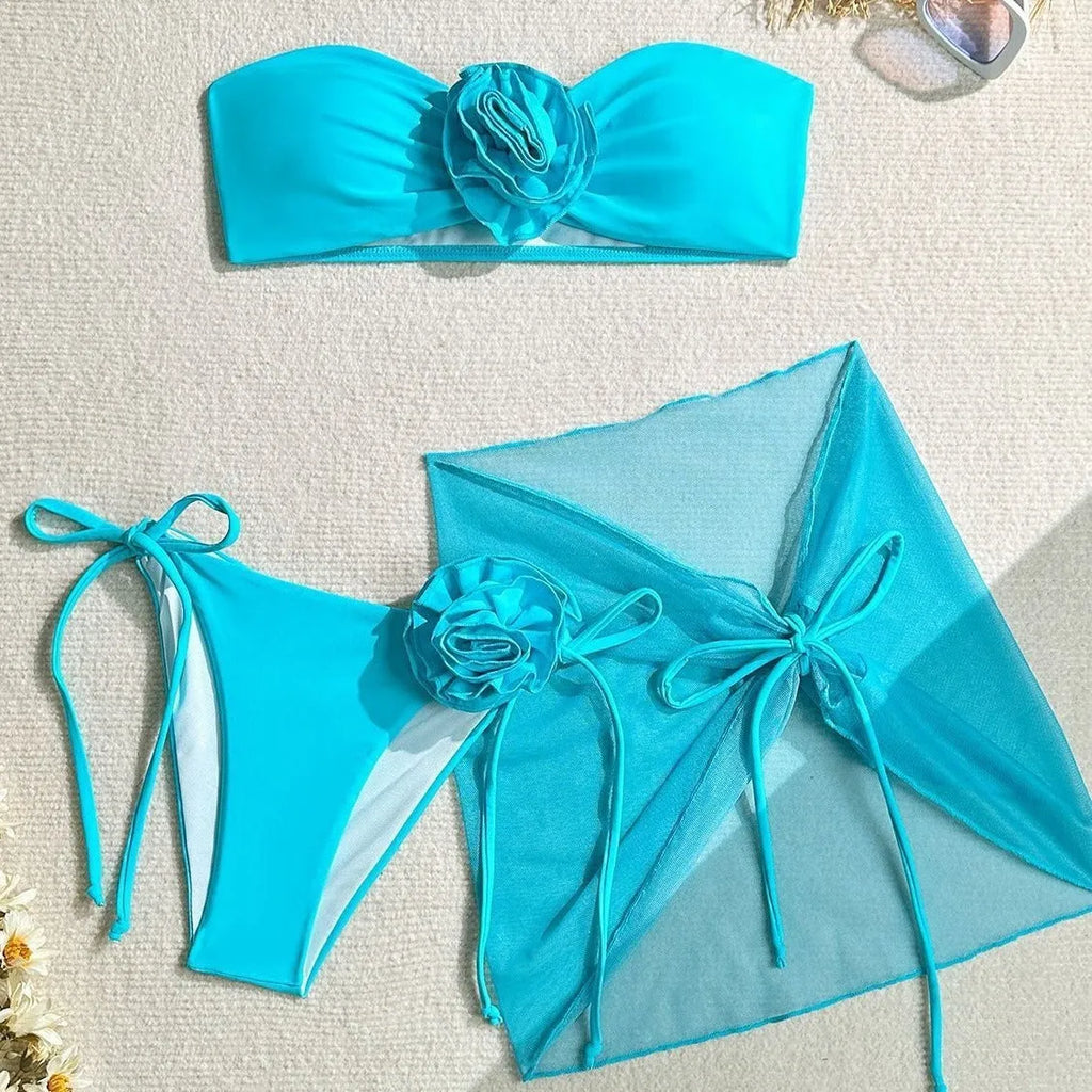 Women's tube top swimsuit with big flower tie, matching pants and skirt in blue