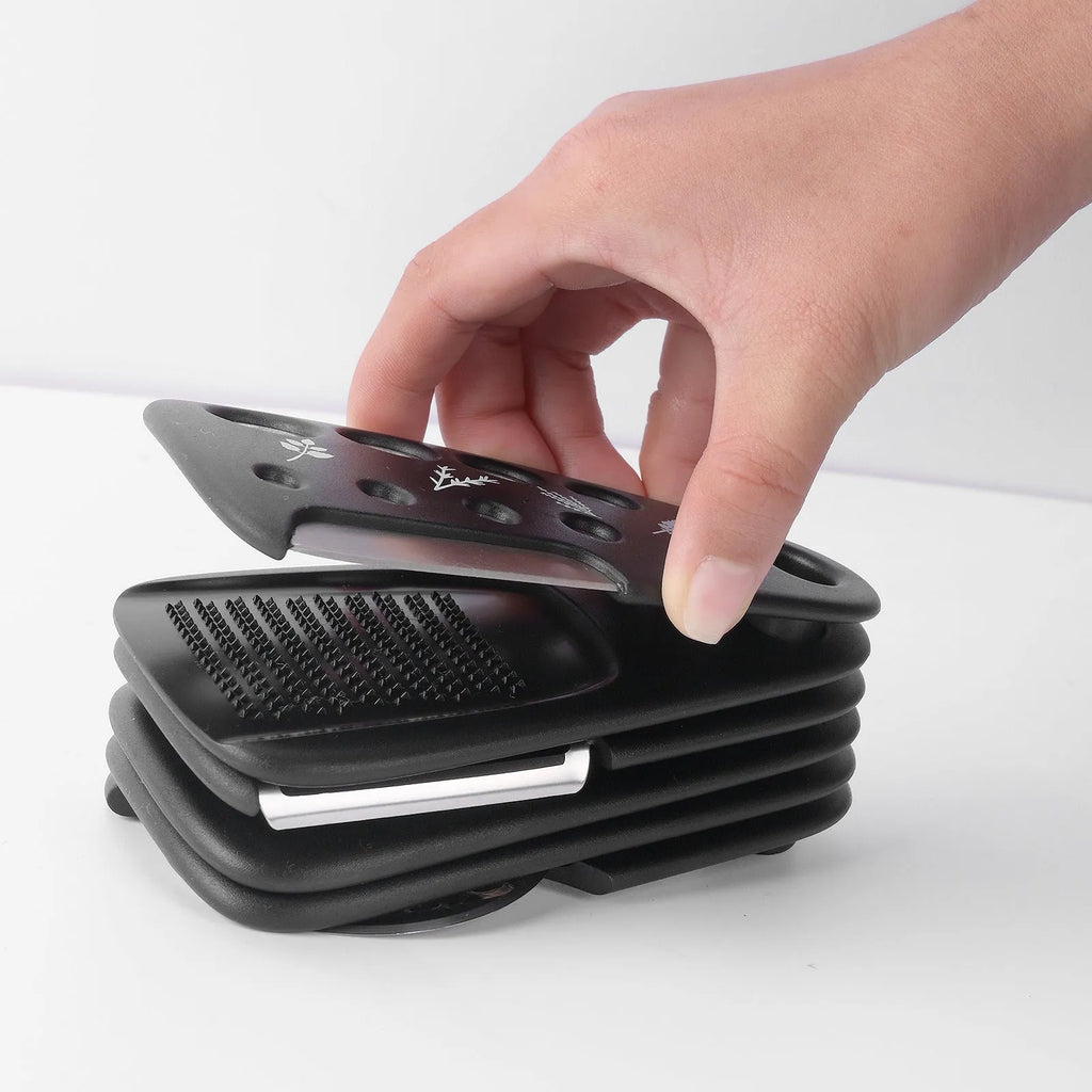 Six kitchen gadgets stacked together with cleaning brush in colour box packaging
