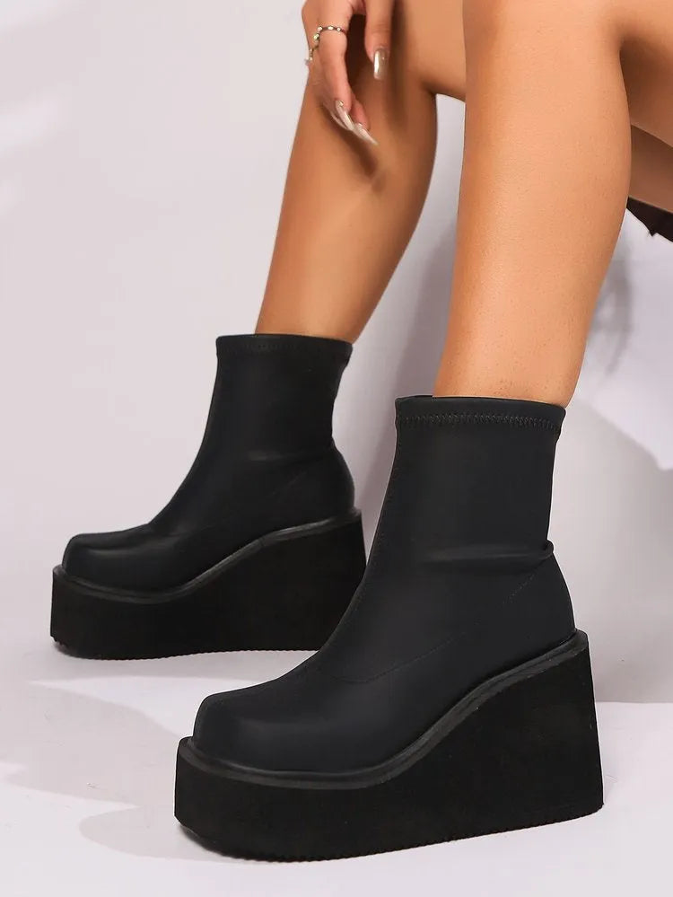 Black plus size women's platform wedge boots with a high shaft and waterproof sole.