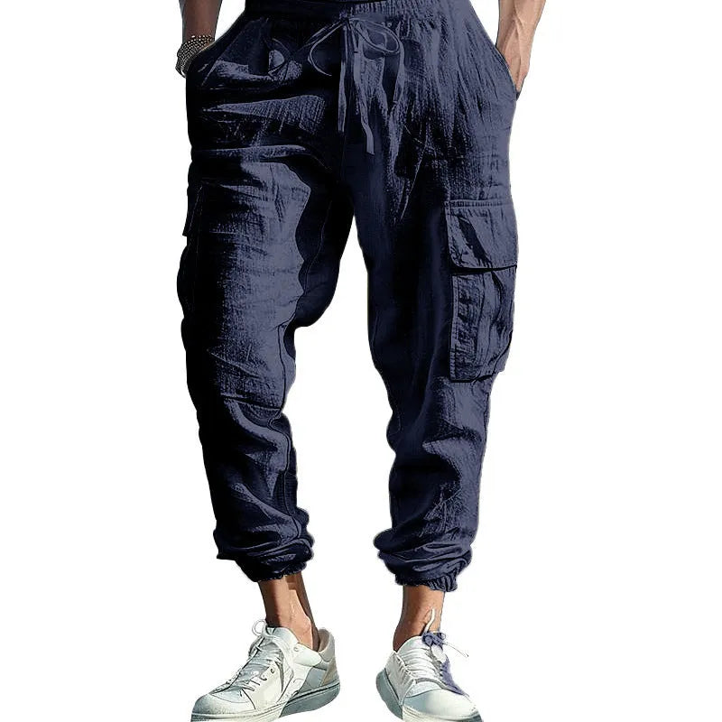 Men's loose fit linen trousers with ankle-tied hem and multiple pockets in army green.