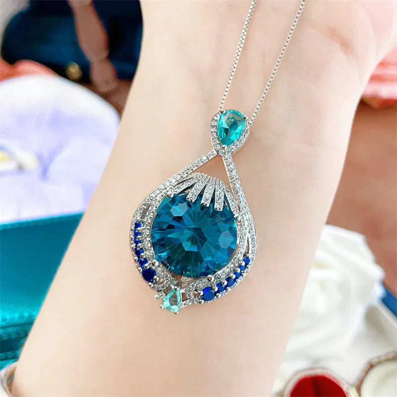 Blue geometric pendant necklace with fireworks cut crystal on a water wave alloy chain for women