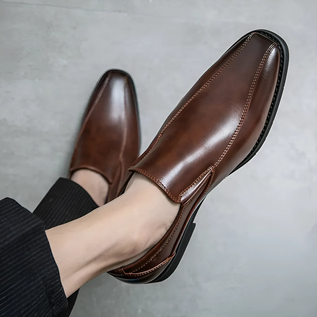 Men's black patent leather pointed toe casual shoes with a flat heel and totem design on a white background.