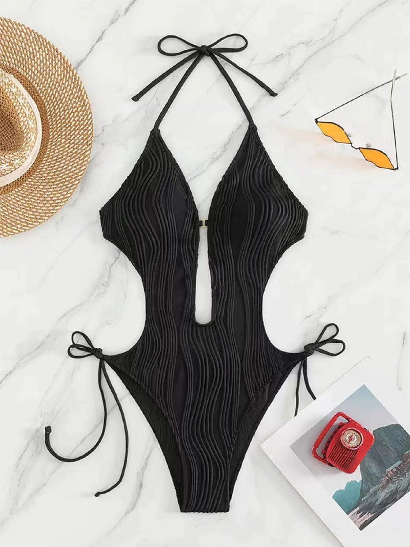 Women's black triangle bikini with adjustable front lace-up detail, shown on a mannequin.