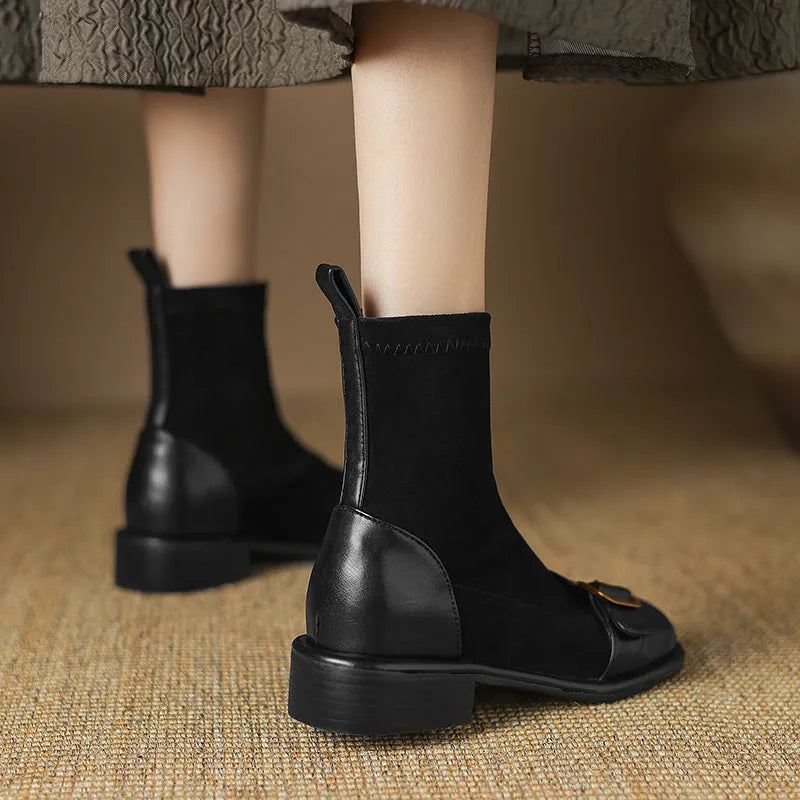 Women's black low heel Martin boots with front lace-up and buckle stitch detail on a round toe.