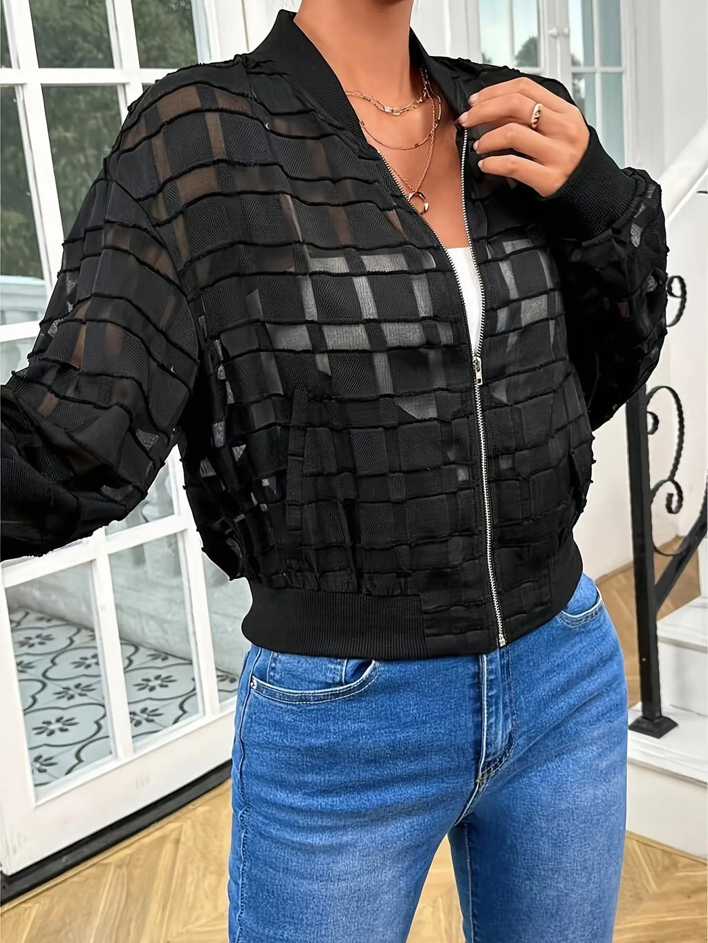 Black women's casual zip jacket with a semi-transparent geometric pattern.