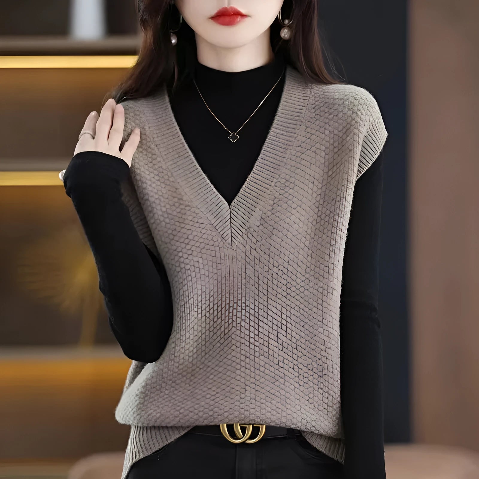 Women's cream V-neck sleeveless knit vest with a raised 3D pattern, laid flat.