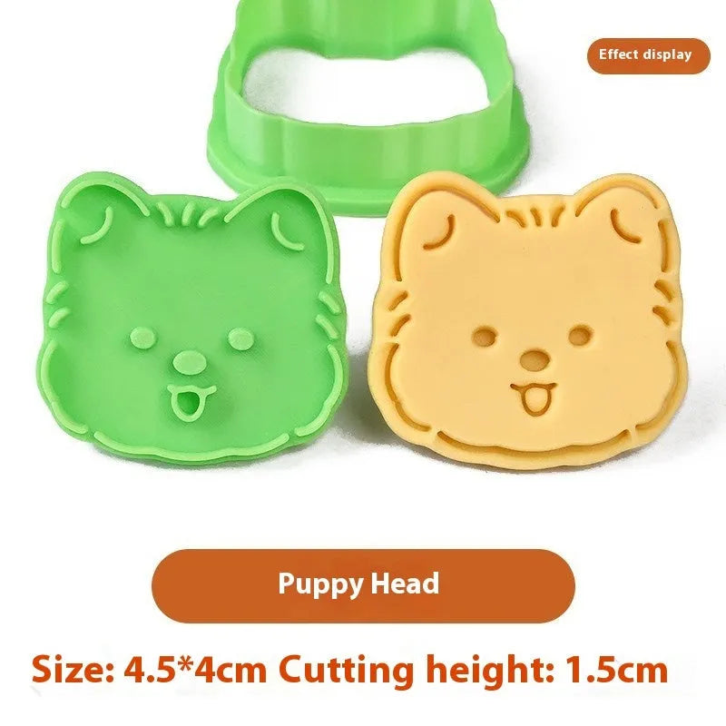 Three dimensional press plastic biscuit mould showing cartoon puppy designs
