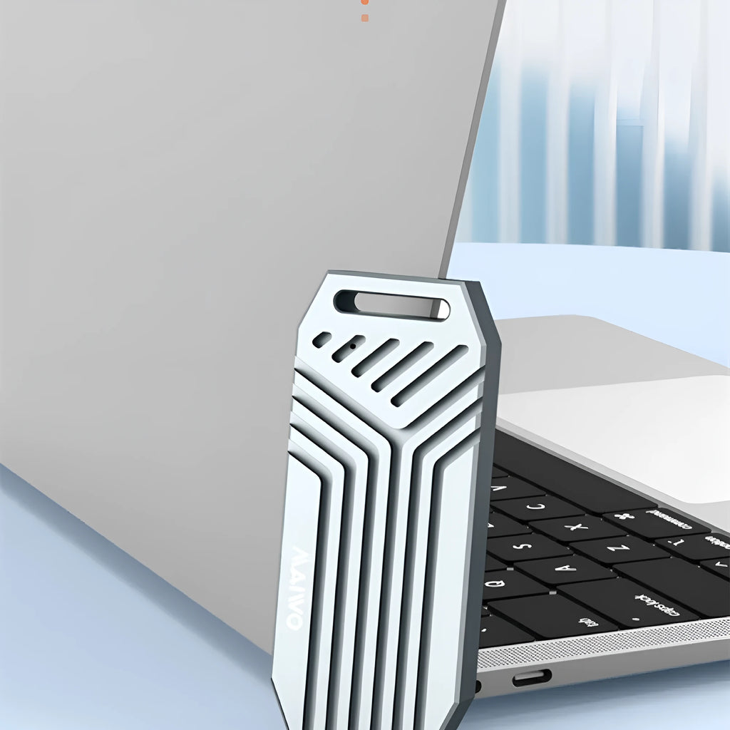 Silver aluminium Thunderbolt 4 external SSD enclosure for M.2 drives with a cooling fan on a desk