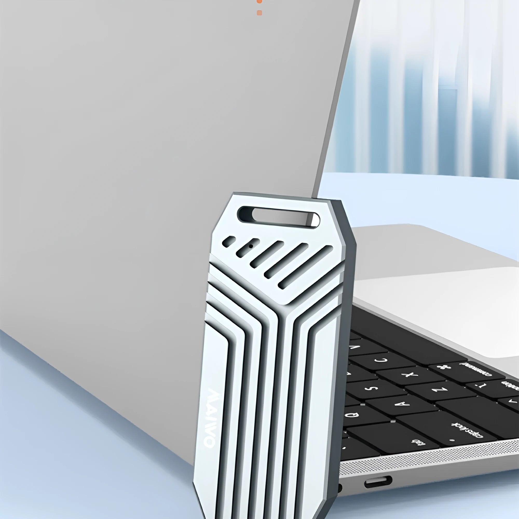 Silver aluminium Thunderbolt 4 external SSD enclosure for M.2 drives with a cooling fan on a desk