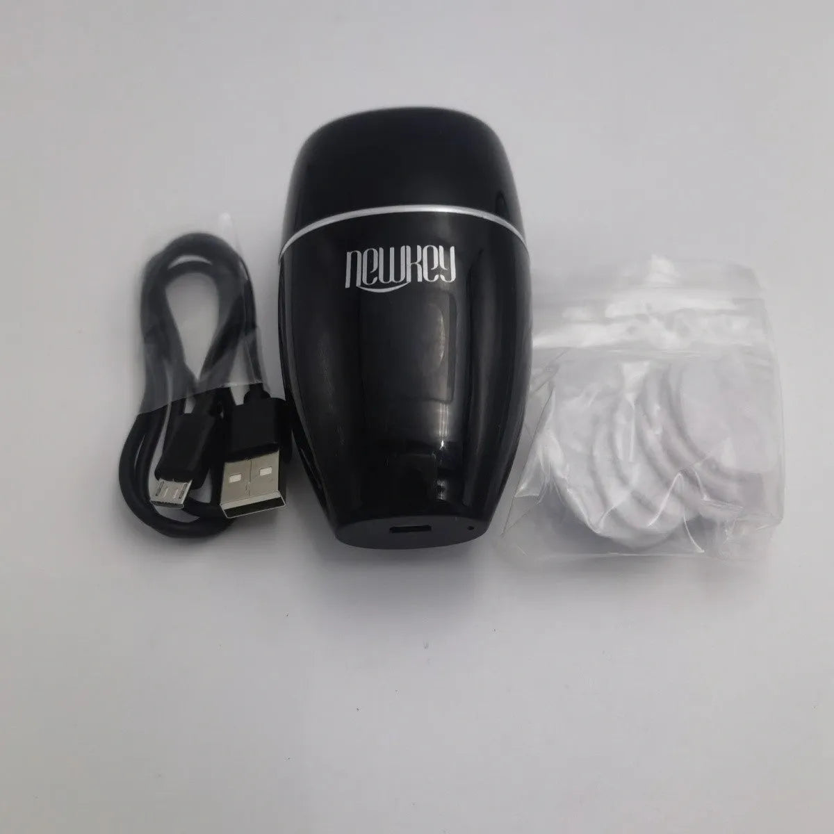 Black and white electric silicone lip plumper device with USB charging cable