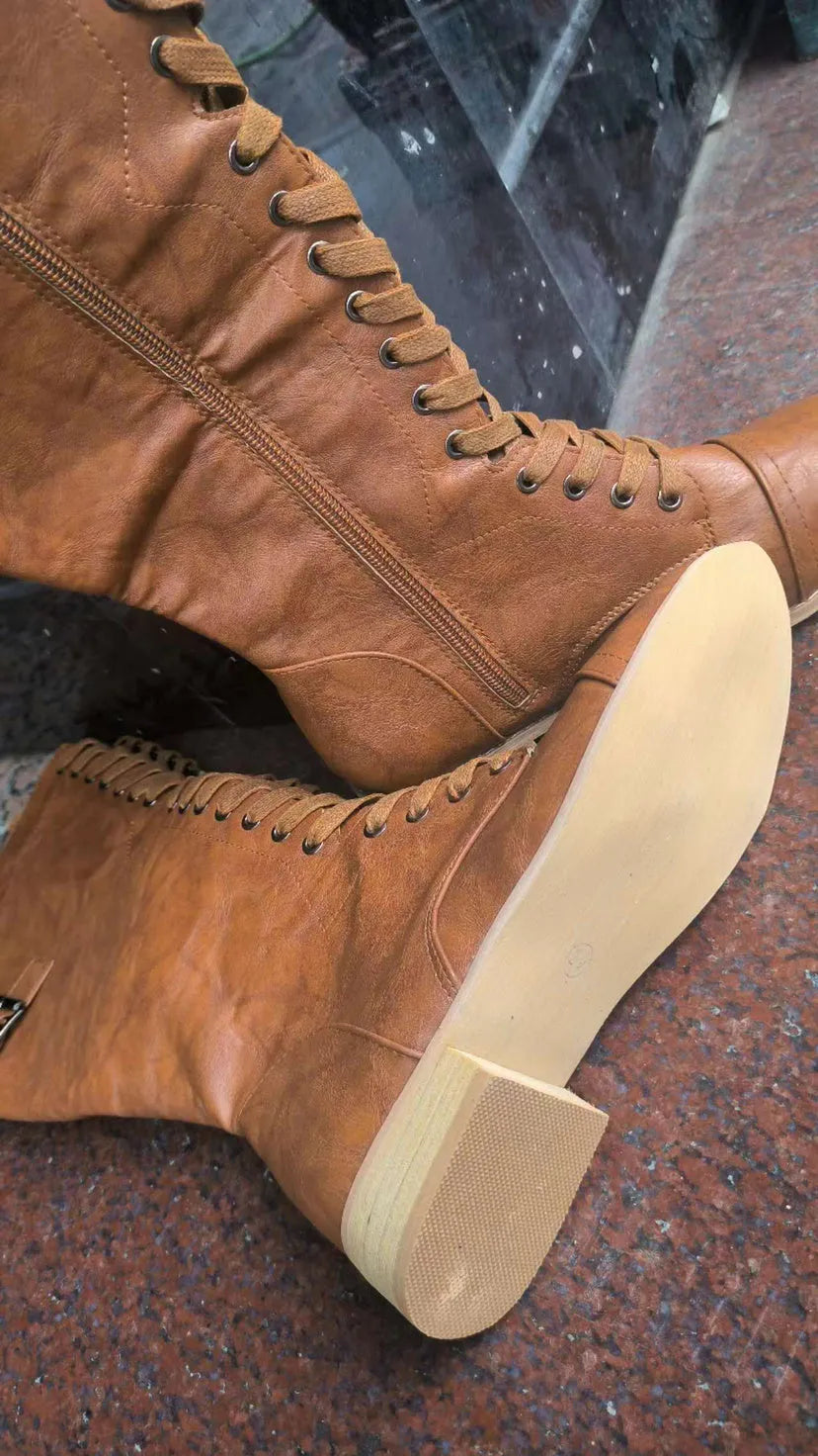 Women's black knight ankle boots with a cross strap detail on the front.